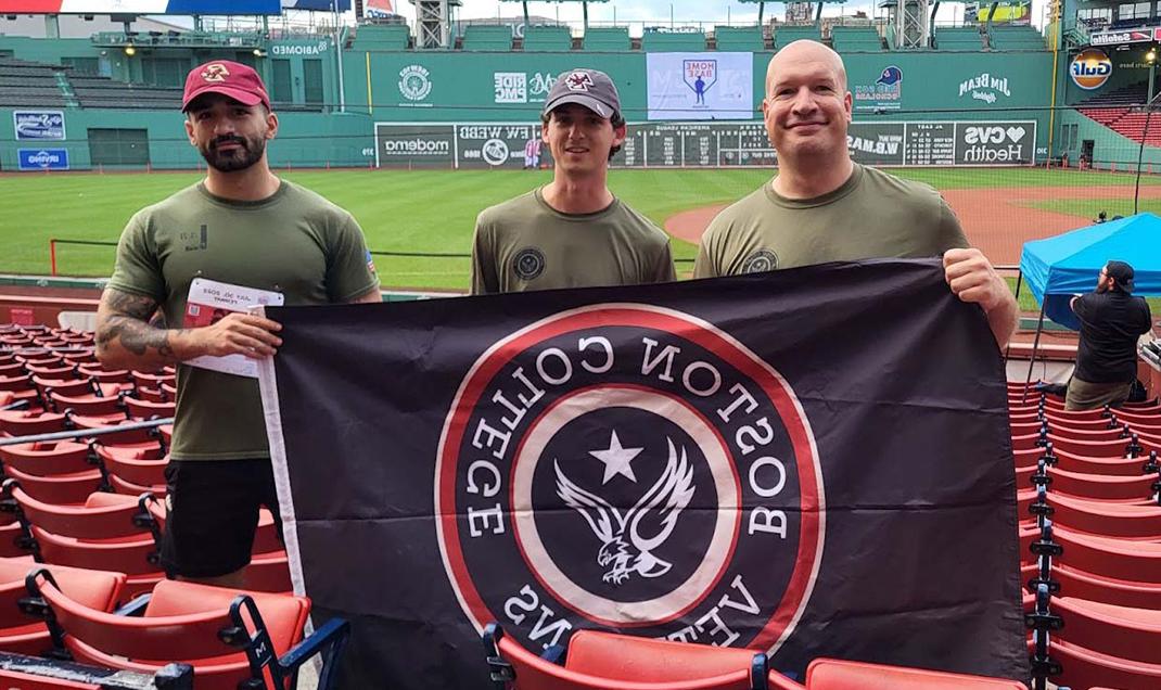 Veterans in a stadium holding the BC Veterans flag